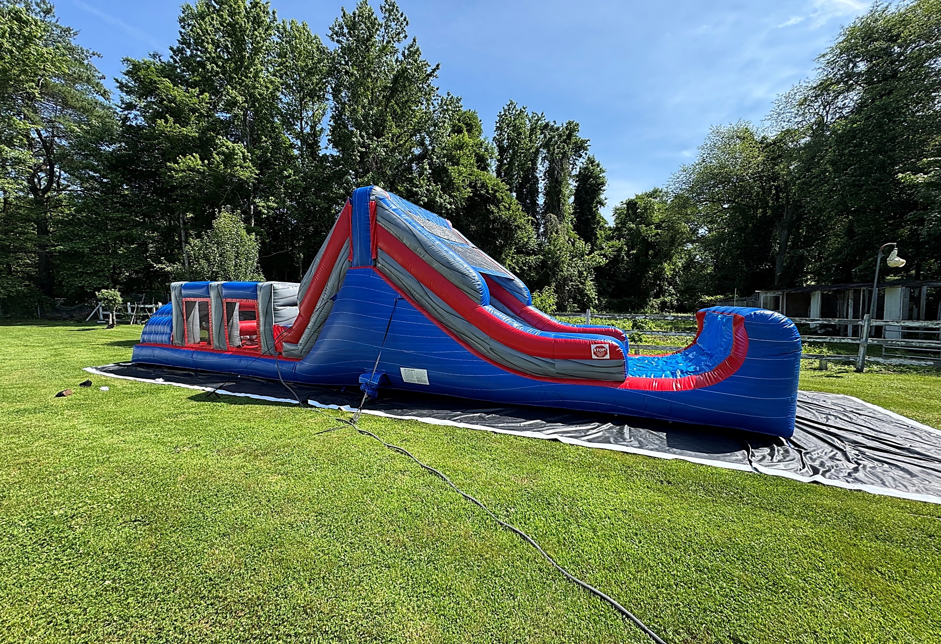 Inflatable Course Runs Race and Run through a Wet Inflatable Obstacle Course with Slides