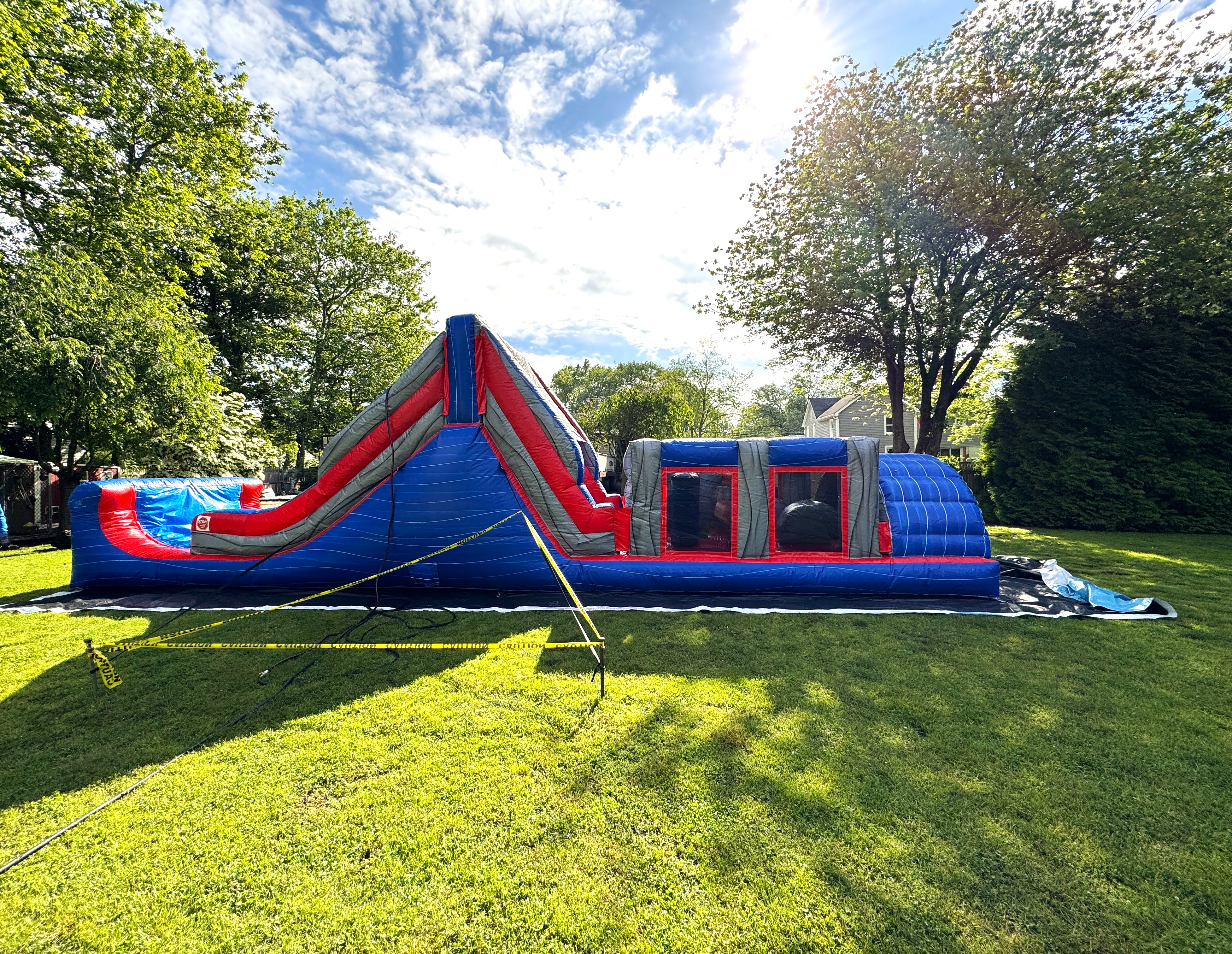 Inflatable Course Runs Race and Run through a Wet Inflatable Obstacle Course with Slides