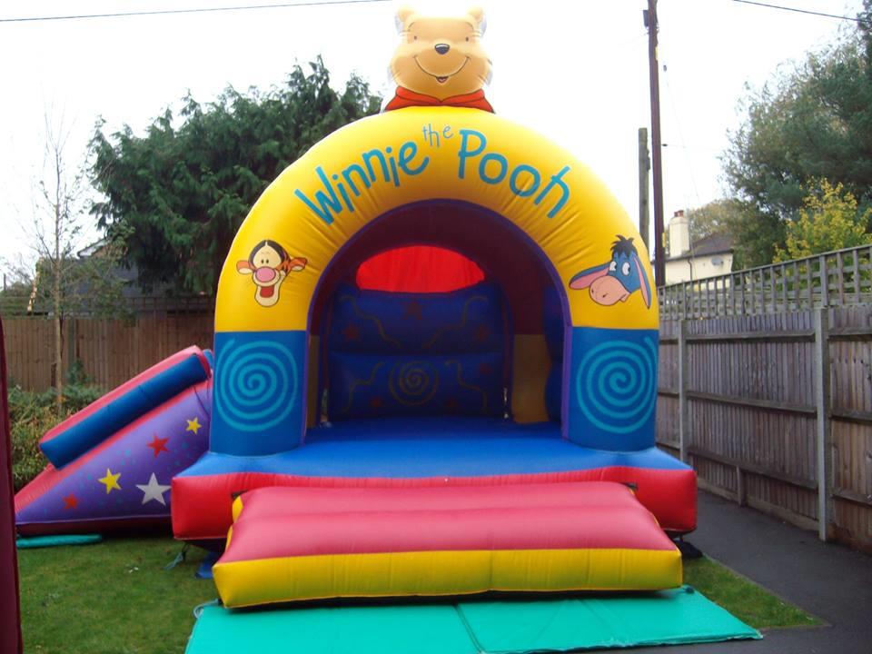 Winnie The Pooh Castle With Slide 15ft x 17ft Bouncy Castle Hire in