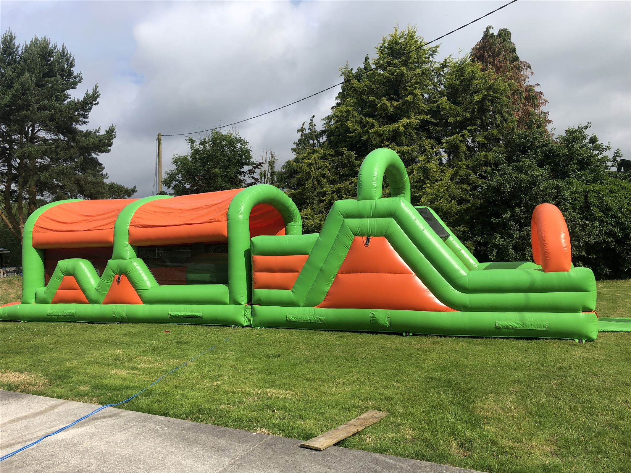 47ft orange and green Rock Climbing Obstacle Bouncy Castle Hire in Co