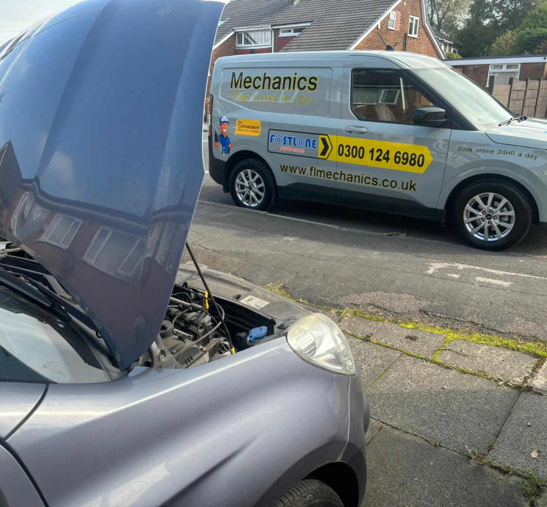 Mobile mechanic carrying out on-site car repairs
