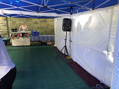 Green Roll-a-Track snap-together flooring laid inside a marquee
