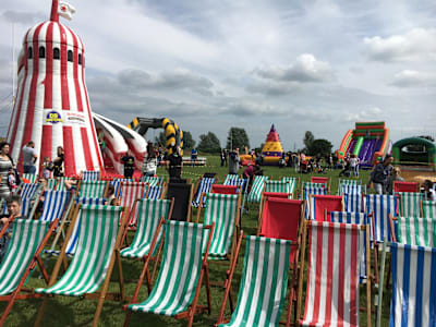 Traditional striped wooden deck chairs set out at an event