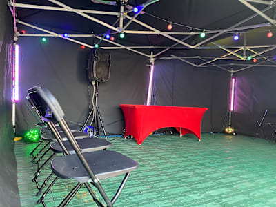 Foldable chairs and a dressed table inside a party marquee
