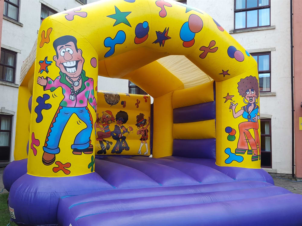 Adult Bouncy Castle Disco Theme 14 x 19 Bouncy Castle Hire in Huddersfield Wakefield M C Bouncy Castle Hire Huddersfield