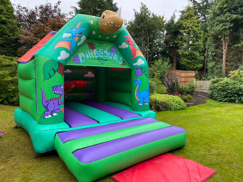 Dinosaur Bouncy Castle 14x12ft Purple Green Bouncy Castle Hire Photo Booth Hire Event Services in Manchester Stockport Chester Rochdale Oldham Macclesfield Warrington King of the Castles