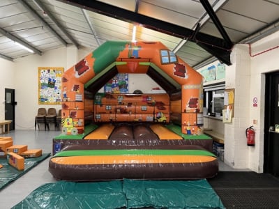 Construction Castle (12ft x 12ft), a bouncy castle for hire from Elmbridge Inflatables