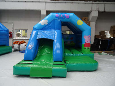 Peppa Pig Bounce N Slide Castle, a bounce and slide combo for hire from Playdays Parties