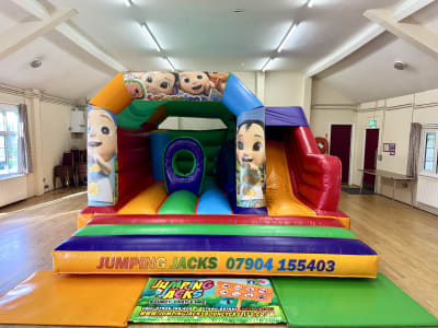 Cocomelon Bounce N Slide Velcro, a bounce and slide combo for hire from Jumping Jacks Bouncy Castles