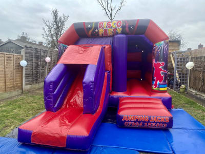 Disco Castle with Slide, a bounce and slide combo for hire from Jumping Jacks Bouncy Castles