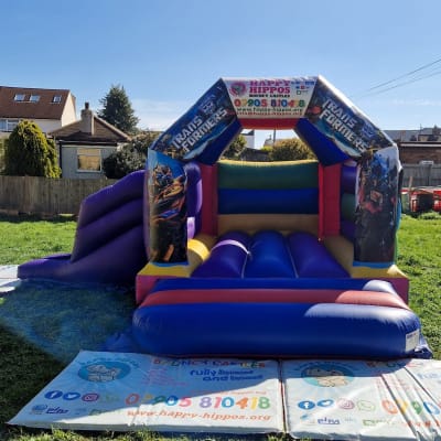 Transformers Slide 15ft x 18ft - Purple & Red, a inflatable slide for hire from Happy Hippos Bouncy Castles