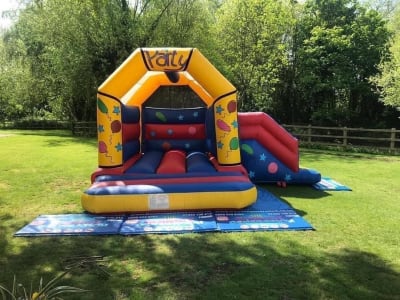 Party Bouncy Castle With Slide (15ft x 17ft), a bounce and slide combo for hire from The Bounce Generation