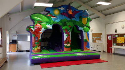 Climb and Slide Dinosaur Kingdom, a inflatable slide for hire from Crockerz Castles