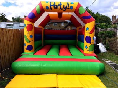 15ft x 12ft Party theme bouncy castle ( LARGE ), a bouncy castle for hire from TFG Bouncy Castles