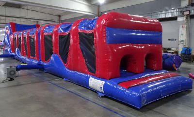 Red and blue obstacle course 70ft, a assault course for hire from Bounce About Sussex