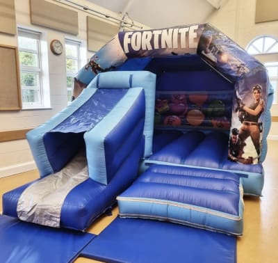 18ft x 12ft Fortnite Bouncy Castle Front Slide, a bounce and slide combo for hire from Bouncy Castle Factory