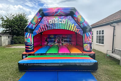 15 x 16 Multicoloured Disco Castle, a bouncy castle for hire from Wazoggies Bounce House