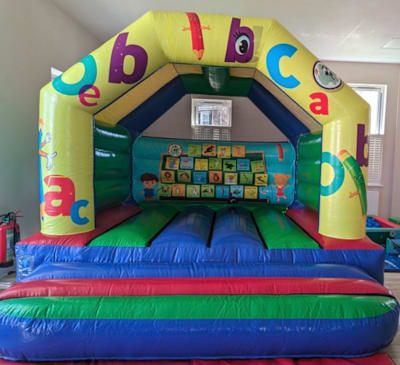Alphabet Castle (12ft x 12ft), a bouncy castle for hire from Elmbridge Inflatables
