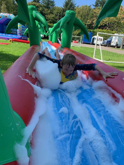 Water Slide Single Lane Inflatable 60ft x 9ft, a inflatable slide for hire from 1st Choice Inflatables