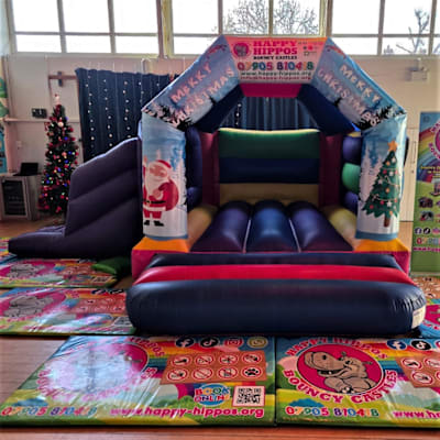 Christmas Slide 15ft x 18ft - Purple & Red, a inflatable slide for hire from Happy Hippos Bouncy Castles