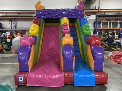Lego Slide with 3D Lego blocks, a inflatable slide for hire from Kendall's Castles