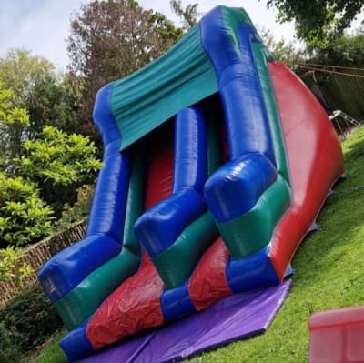 Blue and green slide, a inflatable slide for hire from Bounce About Sussex