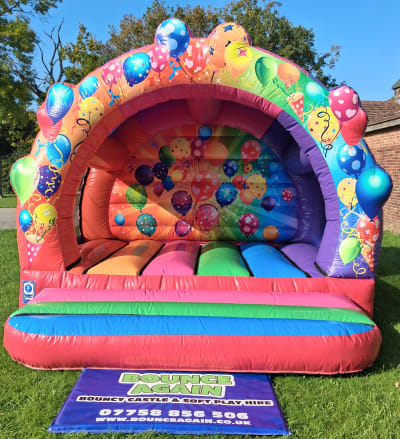 Multi-Coloured Curved Party Bouncy Castle, a bouncy castle for hire from Bounce Again