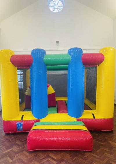 Multicolored Midi Castle, a bouncy castle for hire from Bouncy Mania