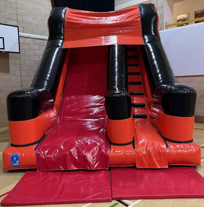 Orange and Black 10ft Platform Slide, a inflatable slide for hire from Crockerz Castles