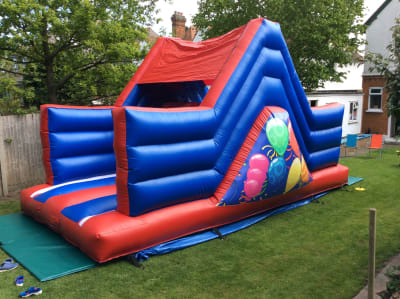 PARTY TIME SLIDE - 10x22x12ft - 6ft Up n Over Slide, a inflatable slide for hire from All Bounce Surrey