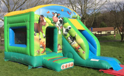 Slide Bouncer Bouncy Castle Farmyard themed with Front Slide, a bounce and slide combo for hire from 1st Choice Inflatables