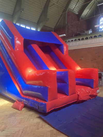 Red and Blue Glossy 8ft Platform Slide, a inflatable slide for hire from Wallington Bouncy Castles