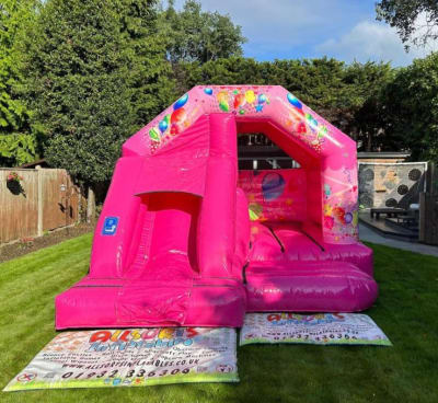 Pink Partytime Castle/Slide Combo, a bounce and slide combo for hire from Allsorts Inflatables
