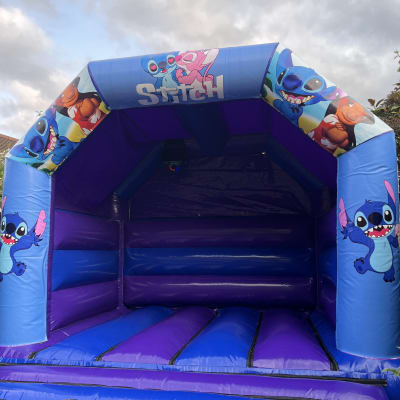 12 ft x 15 ft Lilo and Stitch Character Castle, a bouncy castle for hire from Bouncy Castle Boys