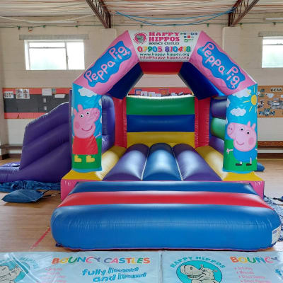 Peppa Pig Slide 15ft x 18ft - Purple & Red, a inflatable slide for hire from Happy Hippos Bouncy Castles