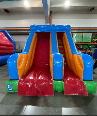 8ft Platform Rainbow Slide, a inflatable slide for hire from Wallington Bouncy Castles