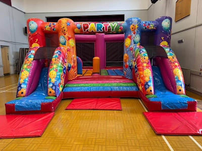 Rainbow Party Midi Twin Slide - INDOORS ONLY, a inflatable slide for hire from Elmbridge Inflatables