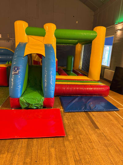 Multi colour low height Bounce and Slide, a bounce and slide combo for hire from Bounce House Inflatables