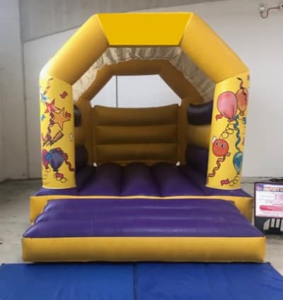 Yellow Party Bouncy Castle, a bouncy castle for hire from Happy Days Bouncy Castles