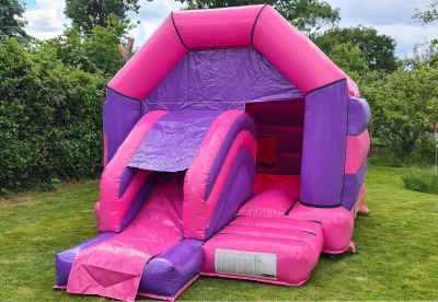 Disco Pink and Purple Castle Slide Combo, a bounce and slide combo for hire from Bouncy Boss
