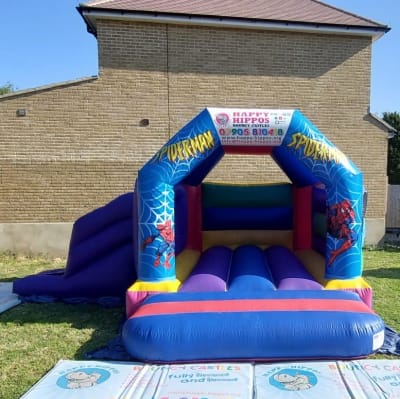 Spiderman Slide 15ft x 18ft - Purple & Red slide, a inflatable slide for hire from Happy Hippos Bouncy Castles