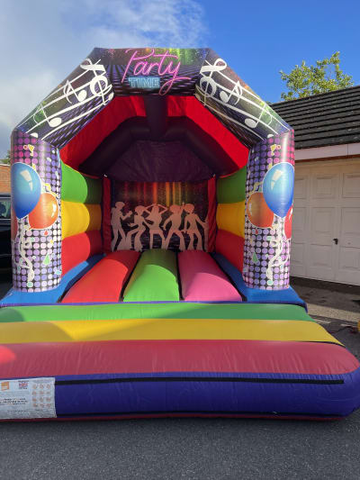 11ft by 15ft Colourful Disco Theme Bouncy Castle, a bouncy castle for hire from Jump Around Bouncy Castles