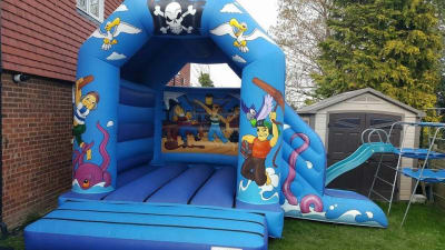14x18 Pirate castle with slide on the side, a bounce and slide combo for hire from Wallington Bouncy Castles