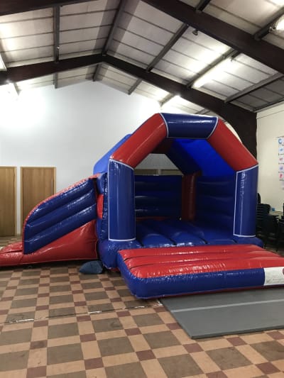 13x16 Gloss Red and Blue Bouncy Castle With Slide, a bounce and slide combo for hire from Wallington Bouncy Castles