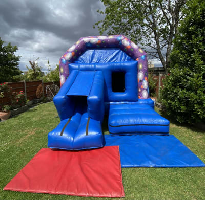 17ft x 12ft Firework Bouncy Castle With A Front Slide, a bounce and slide combo for hire from Bouncy Castle Factory