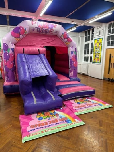 Large Party Time Pink Bouncy Castle, a bouncy castle for hire from Bouncy Castle Fun World