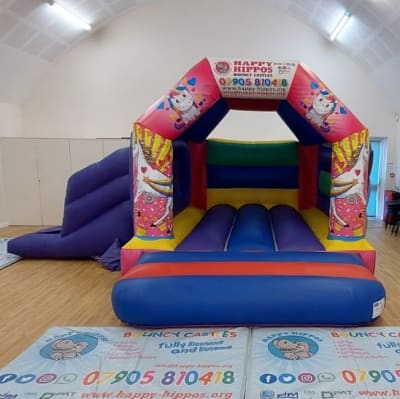 Unicorn Slide 15ft x 18ft - Purple & Red, a inflatable slide for hire from Happy Hippos Bouncy Castles