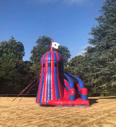 18ft x 18ft Disco Helter Skelter Slide, a inflatable slide for hire from Wizard Bouncy Castles