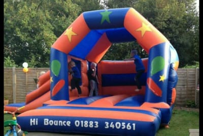 13 X 15 Blue and Orange with slide on the side, a inflatable slide for hire from Wallington Bouncy Castles