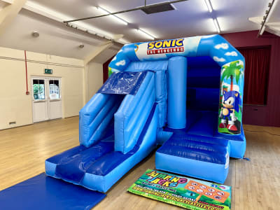Sonic Blue Velcro With Slide, a inflatable slide for hire from Jumping Jacks Bouncy Castles